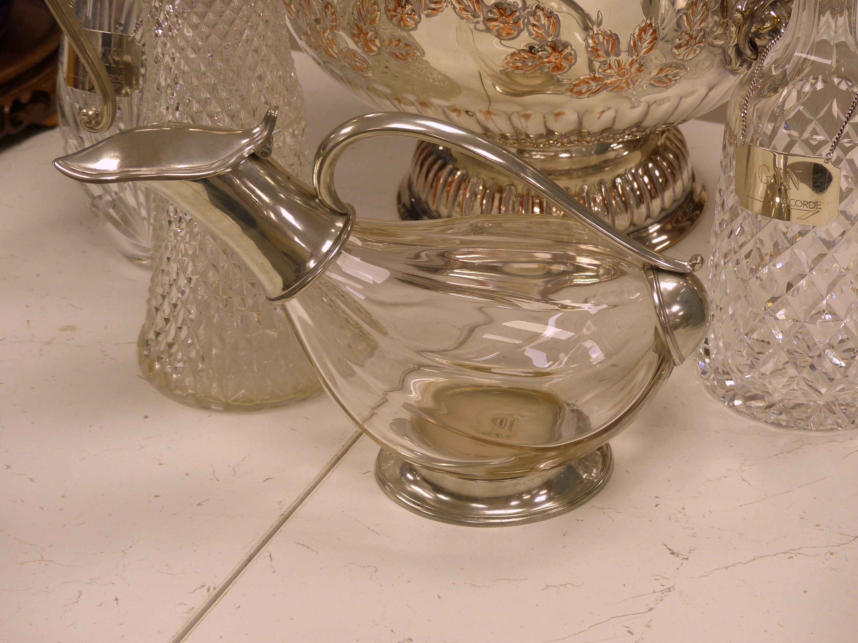 Two cut glass decanters (one silver-mounted), two silver Whisky and Gin labels, an 'Etains du Manoir' duck shaped wine carafe and two other items